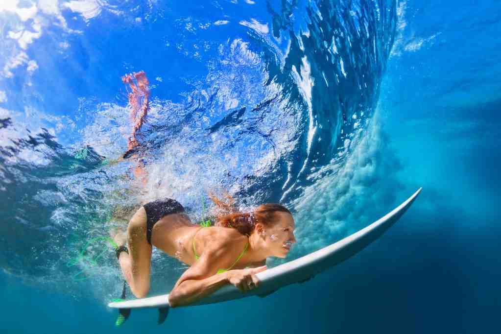 Why do surfers dive into the wave?