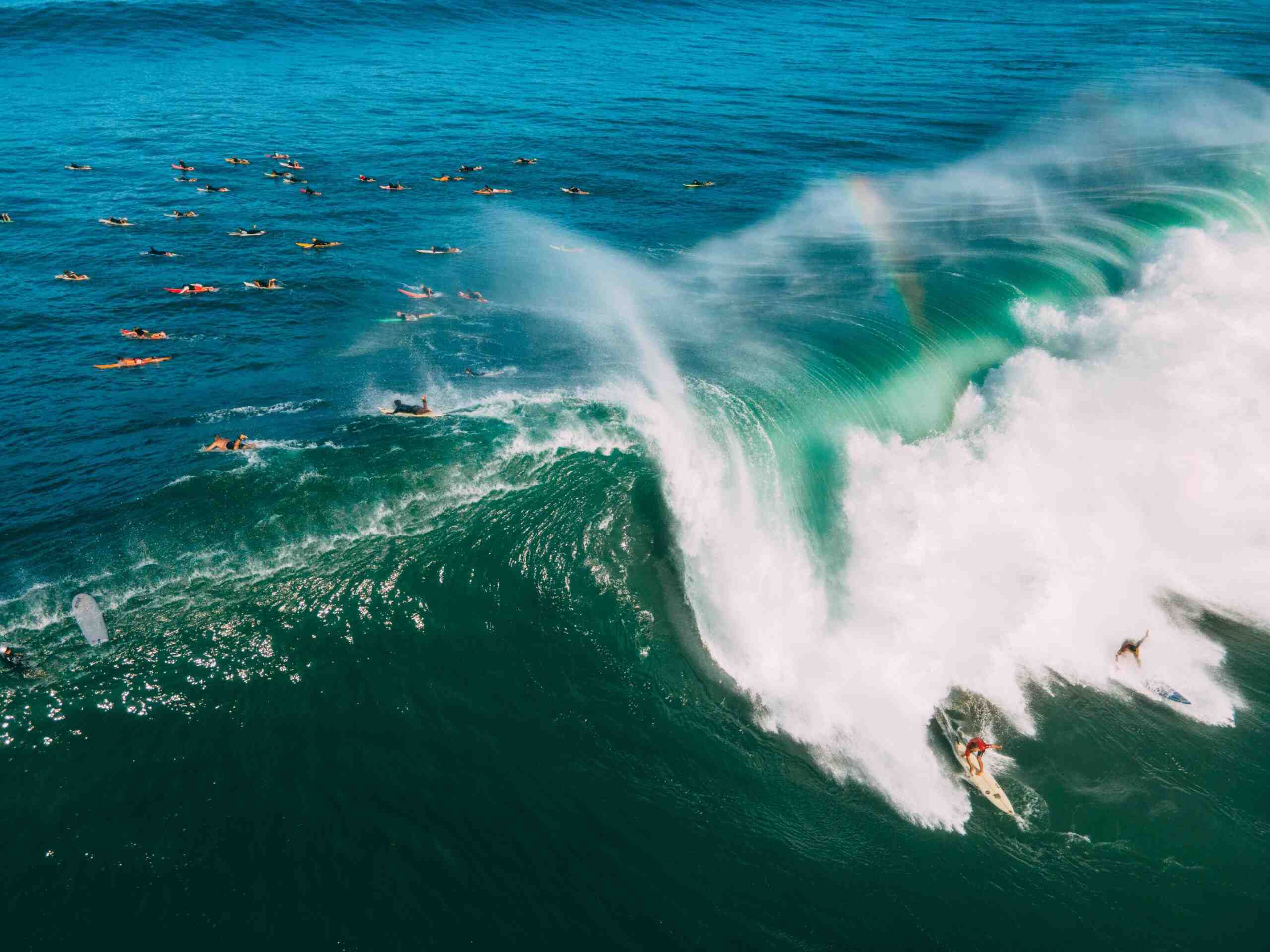 How do surfers deal with big waves?