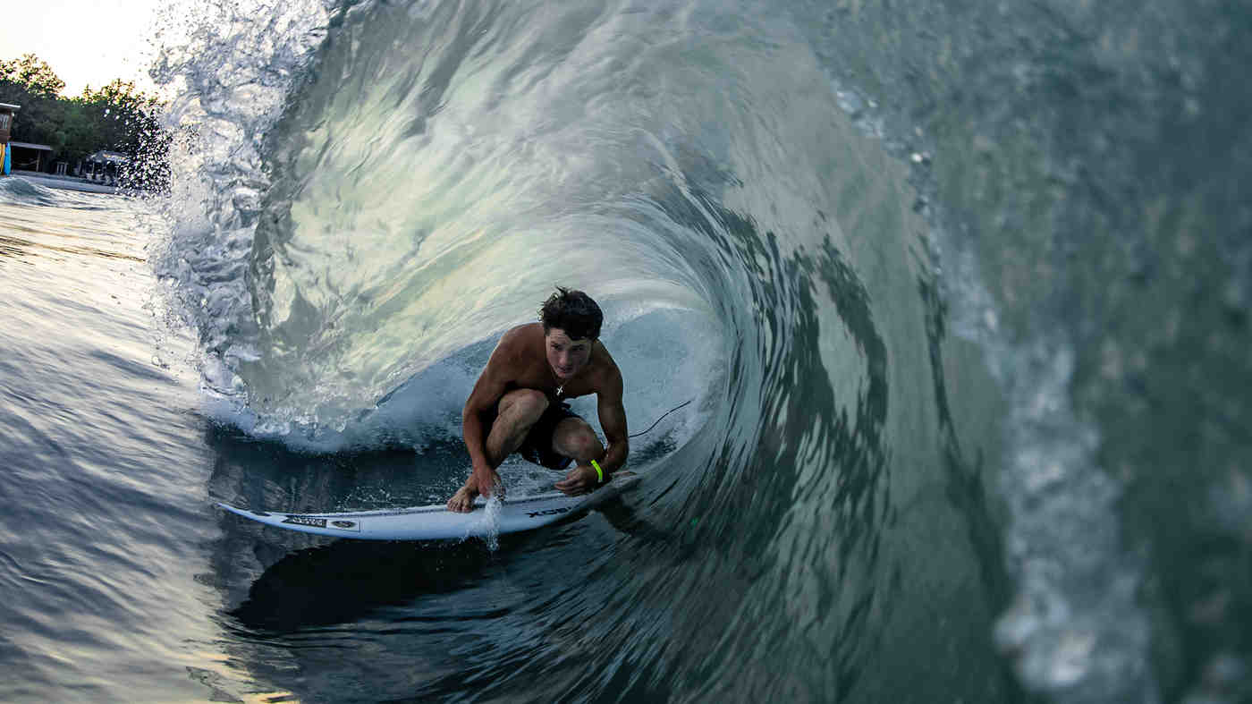 How does a surfer know when to catch a wave?