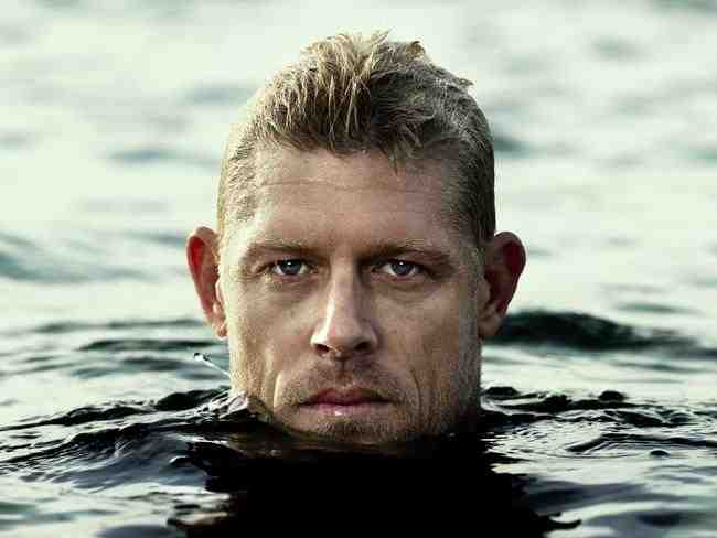 Why did Mick Fanning start surfing?