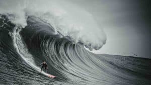 How do surfers deal with big waves?